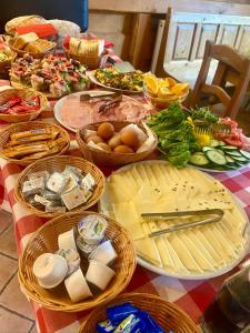 a table with many plates of food on it at Penzion Sofinata & Pizzeria Špindlerův Mlýn in Špindlerův Mlýn