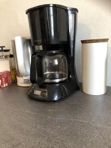 a black coffee maker sitting on a counter at Old Parish Hall, Waldeck Castle in Beltheim