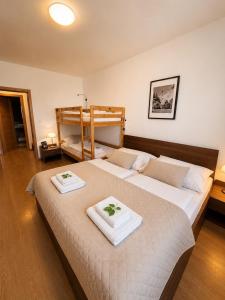 a bedroom with two beds and a bunk bed at Ski IN-OUT Apartmán Donovaly in Donovaly