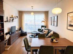 a living room with a couch and a table at Ski IN-OUT Apartmán Donovaly in Donovaly