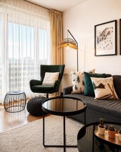 a living room with a couch and a table at Ski IN-OUT Apartmán Donovaly in Donovaly