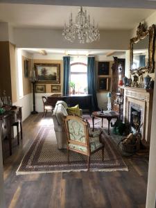 a living room with a couch and a fireplace at Old Parish Hall, Waldeck Castle in Beltheim