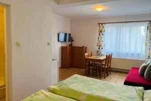 a room with a bed and a table with a dining room at Pokoje Gościnne AKACJA in Swornegacie +13 photos
