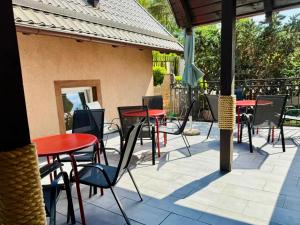 a group of tables and chairs on a patio at Pokoje Gościnne AKACJA in Swornegacie