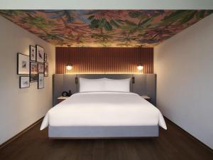 a bedroom with a bed with a painting on the ceiling at Mondrian Seoul Itaewon in Seoul +205 photos