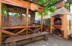 a large wooden structure with a pizza oven at Дача in Kurortne