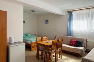 a living room with a table and a couch at Pokoje Gościnne AKACJA in Swornegacie