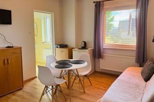 a small living room with a table and chairs at Pokoje Gościnne AKACJA in Swornegacie