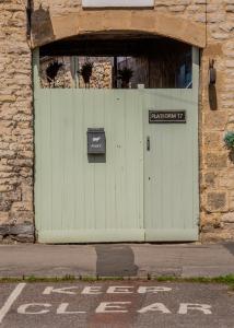 a green door on a building with a sign on it at Platform 17 in Pickering