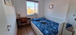 a small bedroom with a bed and a window at Windy Guesthause in Grundarfjordur