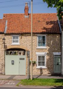 a brick house with a white door and a red roof at Platform 17 in Pickering