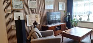 a living room with a television and a table at Windy Guesthause in Grundarfjordur
