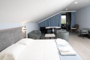 a hotel room with a bed and tables and chairs at GRIG Villa & Hotel in Stepʼanavan +206 photos