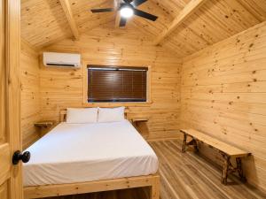 a bedroom in a log cabin with a bed at Zion Vacation Cabins in Virgin +34 photos