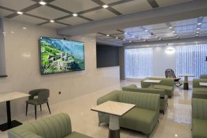 a waiting room with a flat screen tv on the wall at GRIG Villa & Hotel in Stepʼanavan