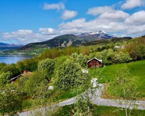 a house on a hill with a lake and mountains at Studio Svartbygget in Åre
