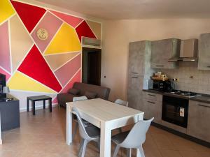 a kitchen with a table and chairs in a room at Alma's house in Donigala Fenughedu +7 photos