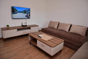 a living room with a couch and a coffee table at Apartments Gajić with Private Free Parking - New & Modern in Bar