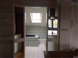 a bathroom with a toilet and a window at Train Fans in Seevetal