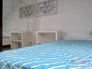 a bedroom with a blue and white bed and shelves at Train Fans in Seevetal