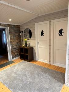 a room with two white doors and a brick wall at Koselig hytte in Skillemo +40 photos