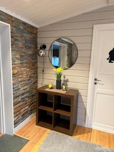 a room with a table and a mirror and a door at Koselig hytte in Skillemo