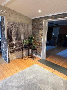 a living room with a fireplace and a brick wall at Koselig hytte in Skillemo