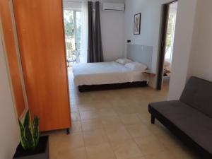 a small bedroom with a bed and a couch at Forest Calm Faliraki in Faliraki +83 photos