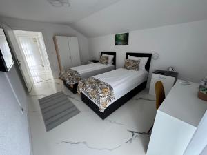 a bedroom with two beds and a window at AM Una Lux House in Bihać +59 photos