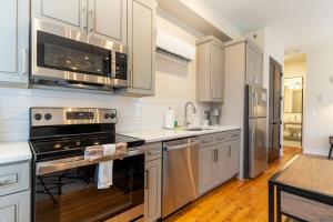 a kitchen with stainless steel appliances and white cabinets at The Saint Clair in Frankfort