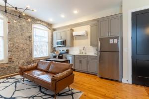 a living room with a couch and a kitchen at The Saint Clair in Frankfort