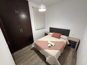 a small bedroom with a bed and a mirror at Casa Javi y Carmen B Iz in Coto Ríos