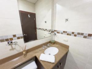 a bathroom with a sink and a mirror at Amazing apartment near US Consulate in Guayaquil