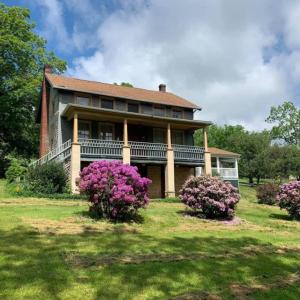 a large house with purple flowers in front of it at The Cortina Inn in Donegal