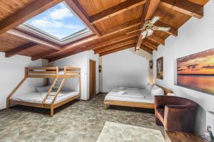 a bedroom with two bunk beds and a skylight at Gästehaus Parkblick in Rust