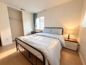 a bedroom with a large bed and a window at Spacious Private Bedrooms With Full Amenities Near Grocery Stores & Main Highway Routes in Fontana