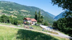 a house on the side of a hill with a road at Chalet de l'Epigny in Bellecombe