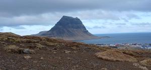 a mountain on top of a hill near the ocean at Windy Guesthause in Grundarfjordur