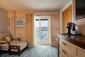 a room with a chair and a door with a window at Boothbay Harbor Inn in Boothbay Harbor