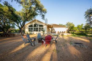 a group of chairs sitting in front of a building at Private Luxury Getaway | Fire Pit | Near Weddings in Dripping Springs