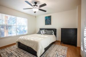 a bedroom with a bed and a ceiling fan at Private Luxury Getaway | Fire Pit | Near Weddings in Dripping Springs