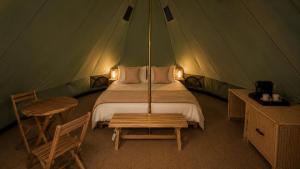 a bedroom with a bed in a tent at La Ballenera Lodge in Guaquen