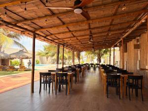 a row of tables and chairs on a patio at Hotel La Mar Playas in Playas