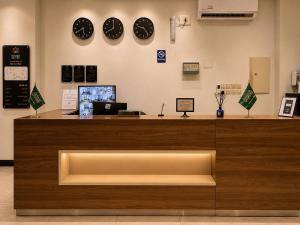 a counter in a store with clocks on the wall at شركة نيلوفر بلس للخدمات الفندقيه in Abha +16 photos