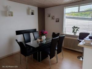 a dining room with a black table and chairs at Venos rooms in Hirtshals +16 photos