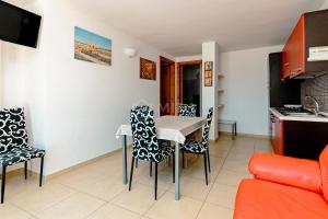 a kitchen and dining room with a table and chairs at Arabic Sea Apartments in Porto Cesareo