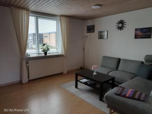a living room with a couch and a table at Venos rooms in Hirtshals