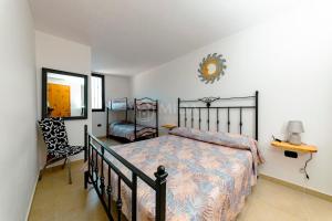 a bedroom with a bed and a table and a chair at Arabic Sea Apartments in Porto Cesareo