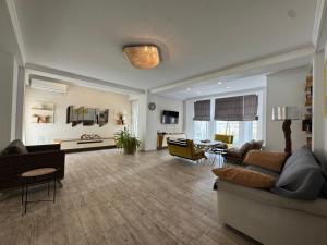 a large living room with a couch and chairs at RestCoast Villa in Shekhvetili