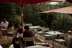 a group of people sitting at tables in a restaurant at La Dime de Giverny - Chambres d'hôtes-Spa-Restaurant in Giverny